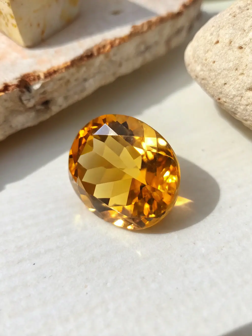 Image of a citrine crystal cluster with golden hues, placed on a wooden surface to highlight its warm, inviting color and association with abundance and prosperity.